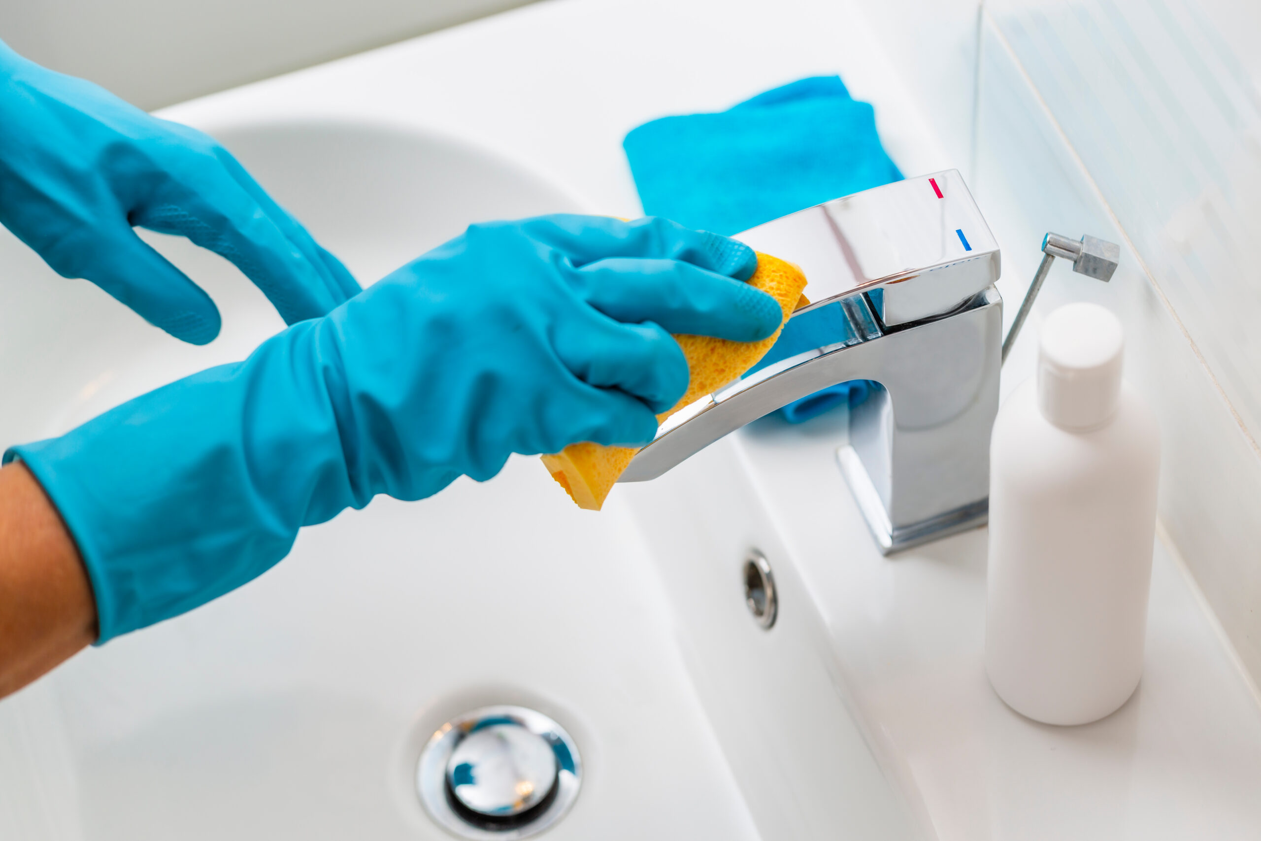Cleaning sink and faucet with detergent.Coronavirus prevention,