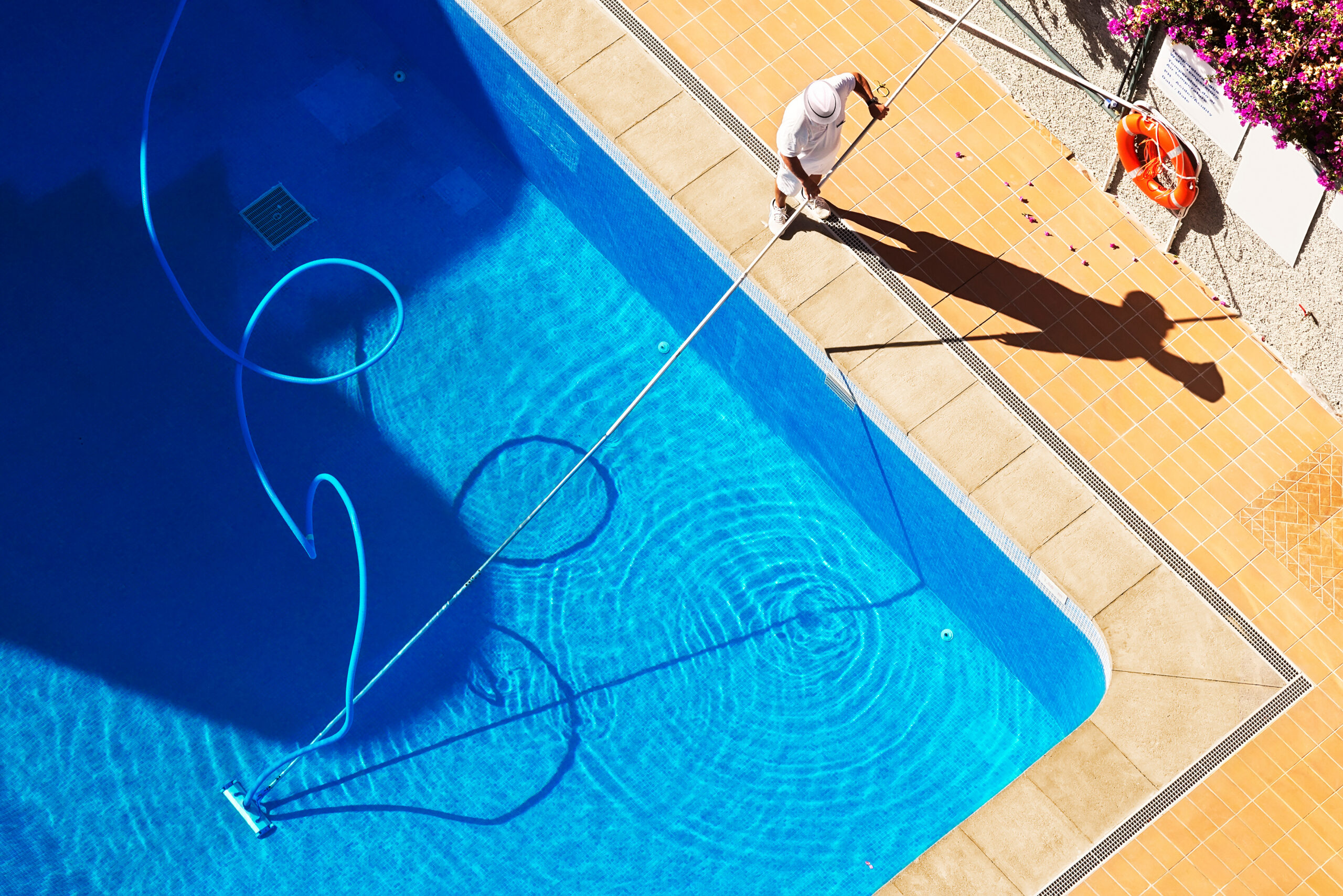 wimming pool cleaning to maintenance by lifeguard worker